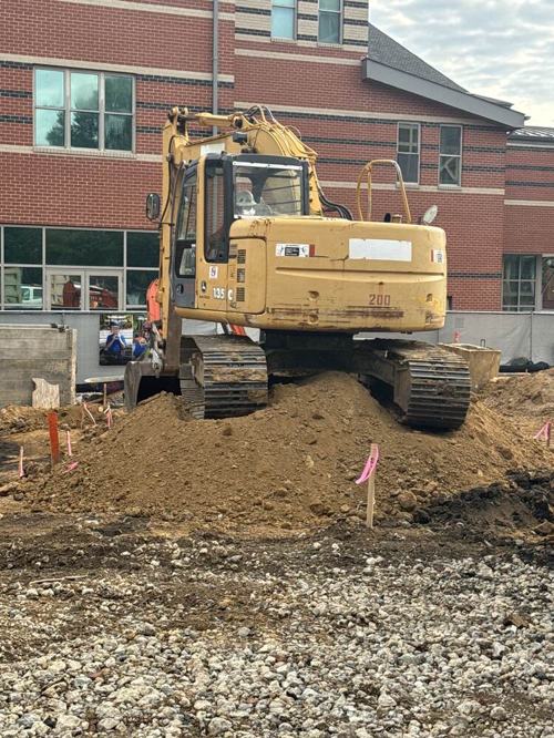 Excavator grading a site